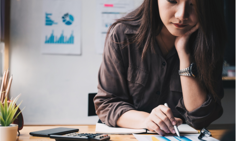 business woman using calculator doing math